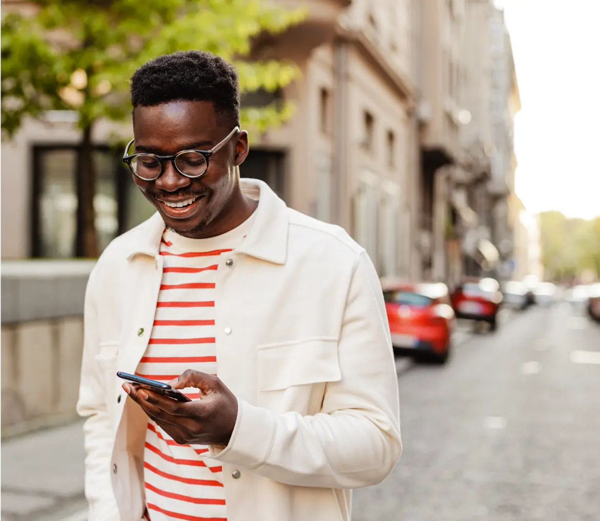 Young gentleman walking and scrolling on his phone