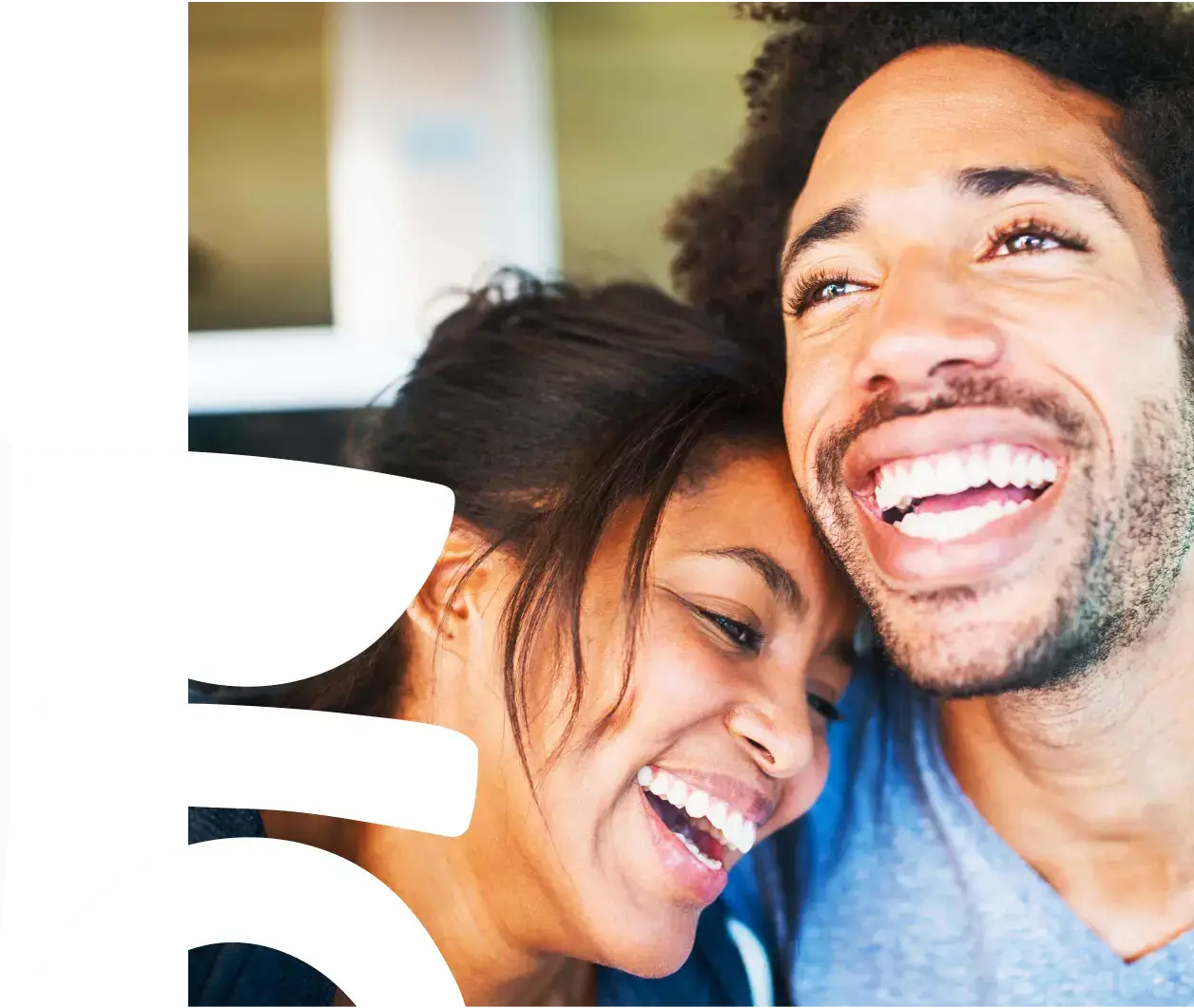 A couple holding each other and laughing happily